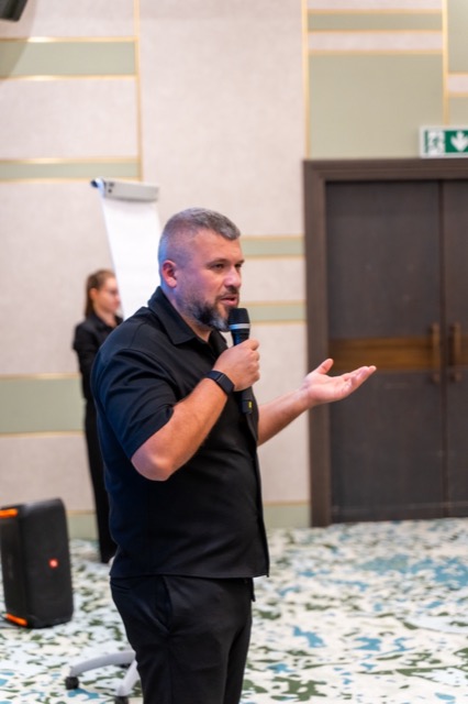 Mikhail Zelenin speaking with a microphone